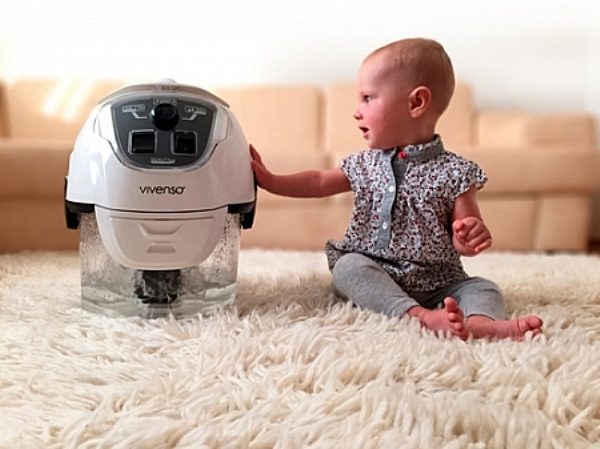Baby and vacuum cleaner