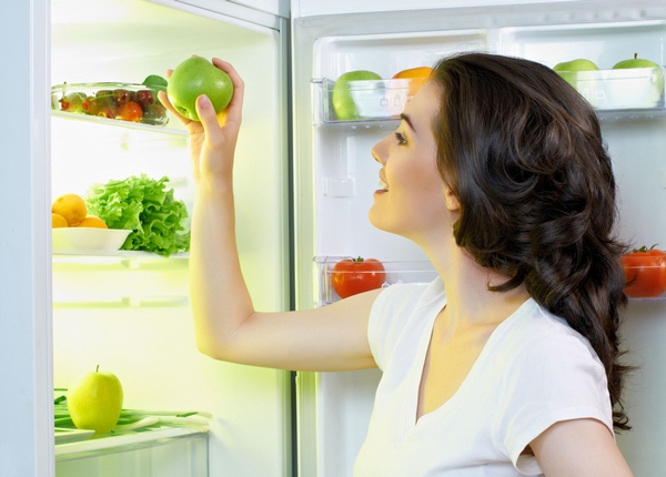 Drip system Girl puts an apple in the fridge