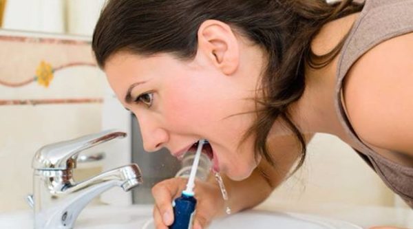 The procedure of cleaning the mouth with irrigator The procedure of cleaning the mouth with irrigator