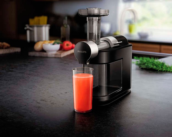 Juicer and glass of grapefruit juice