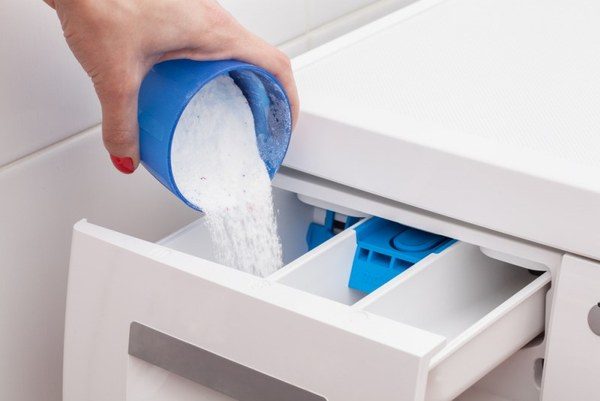 Loading detergent in a special tray Loading detergent in a special tray