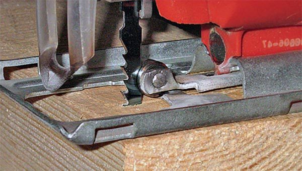 Sawing on a tree with an electric jigsaw