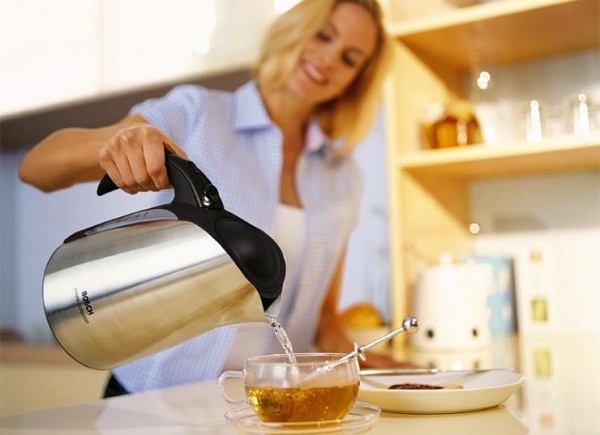 Girl making tea in a cup