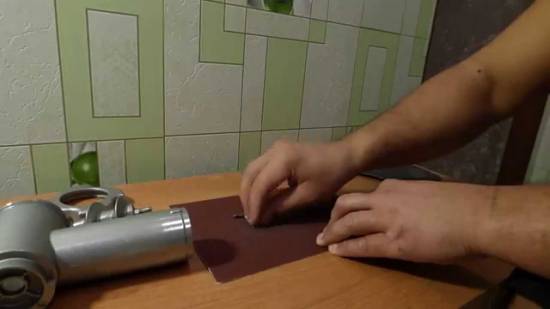 Grinding on emery cloth
