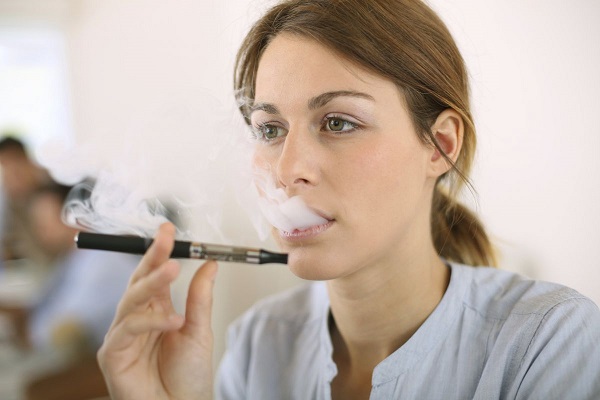 Girl smokes electronic cigarette