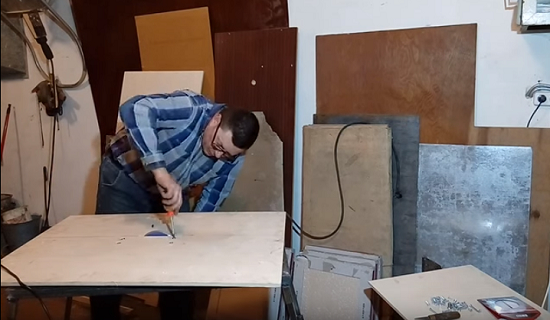 Tile cutter with grinder bottom
