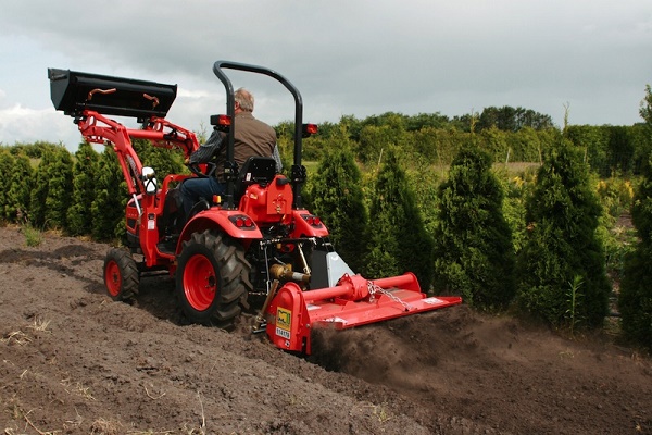 Tractor plows the ground
