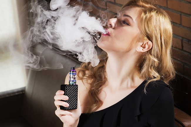 Girl smokes vape