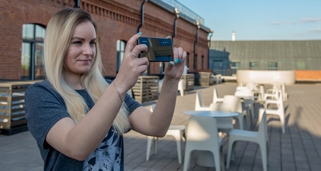 Girl takes a picture with a smartphone
